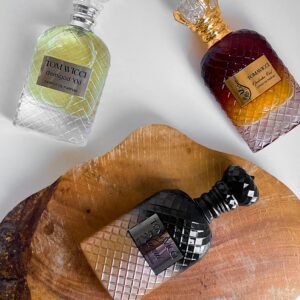 Artistic display of luxury perfume bottles on wooden surface for elegant branding.